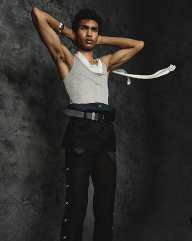Black denim-style bib apron with belt, layered front panels, and snap buttons