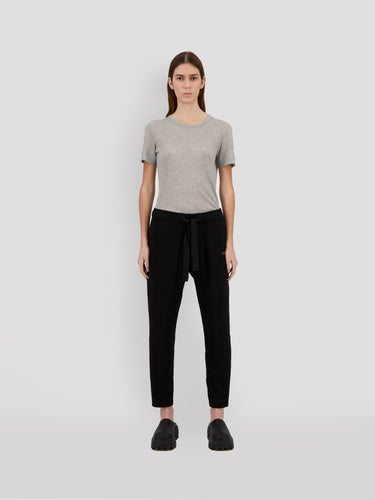 Black cropped sweatpants with drawstring waist; model front view, full length legs.