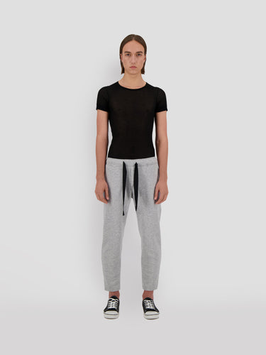 Cropped gray sweatpants with black drawstring waist and relaxed tapered legs