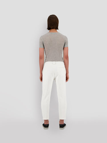 Cropped white sweatpants with black drawstring and small Theo logo, rear view