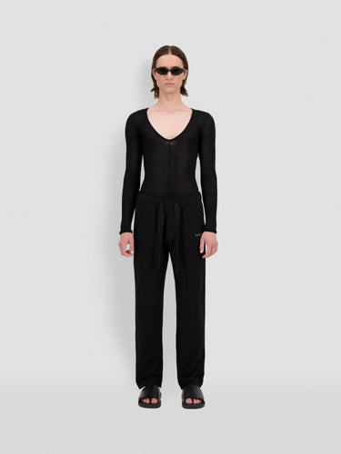 Black straight-leg sweatpants with small 3D Theo logo at hip